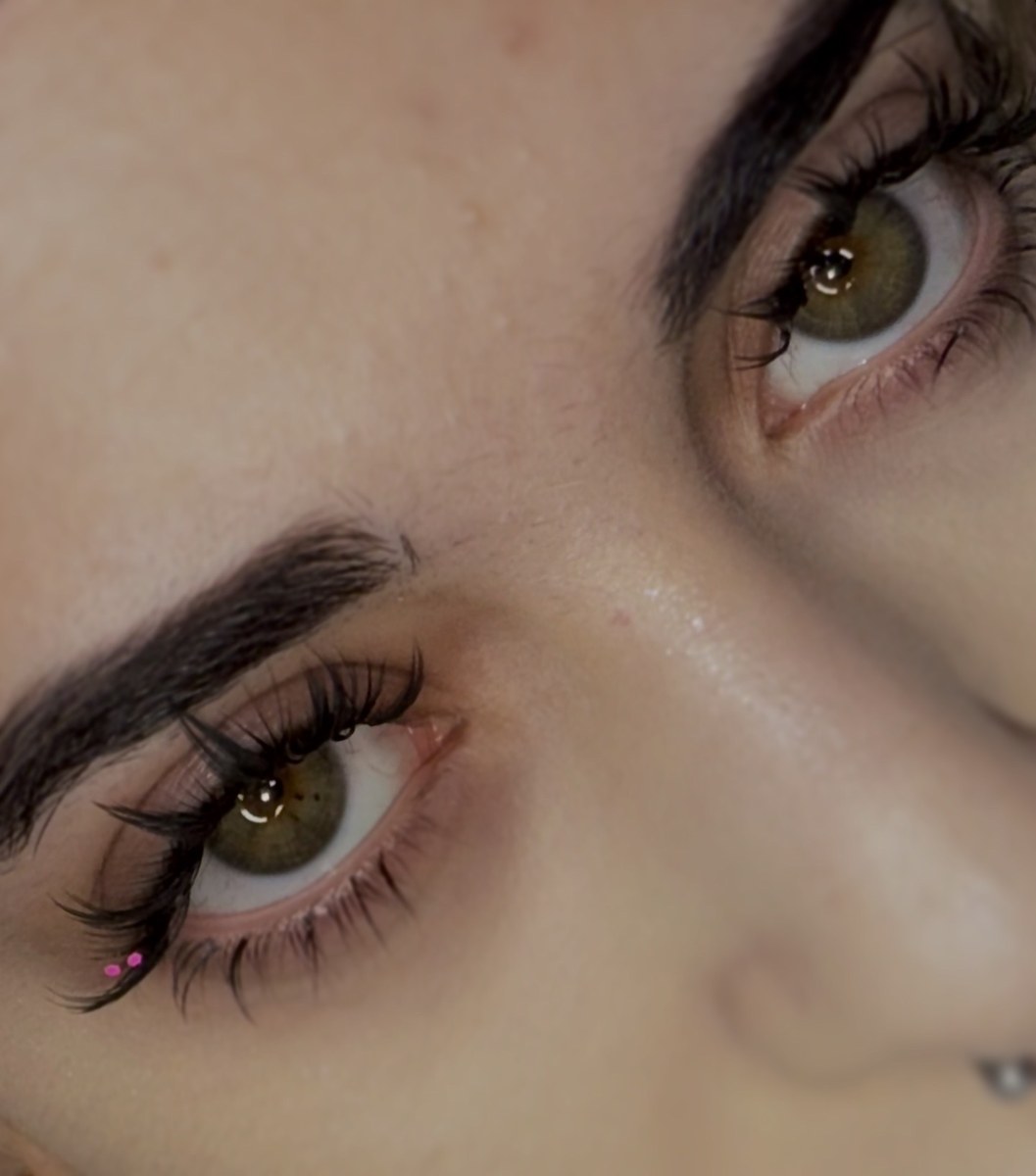 Green eyes with wispy anime lashes and pink gems