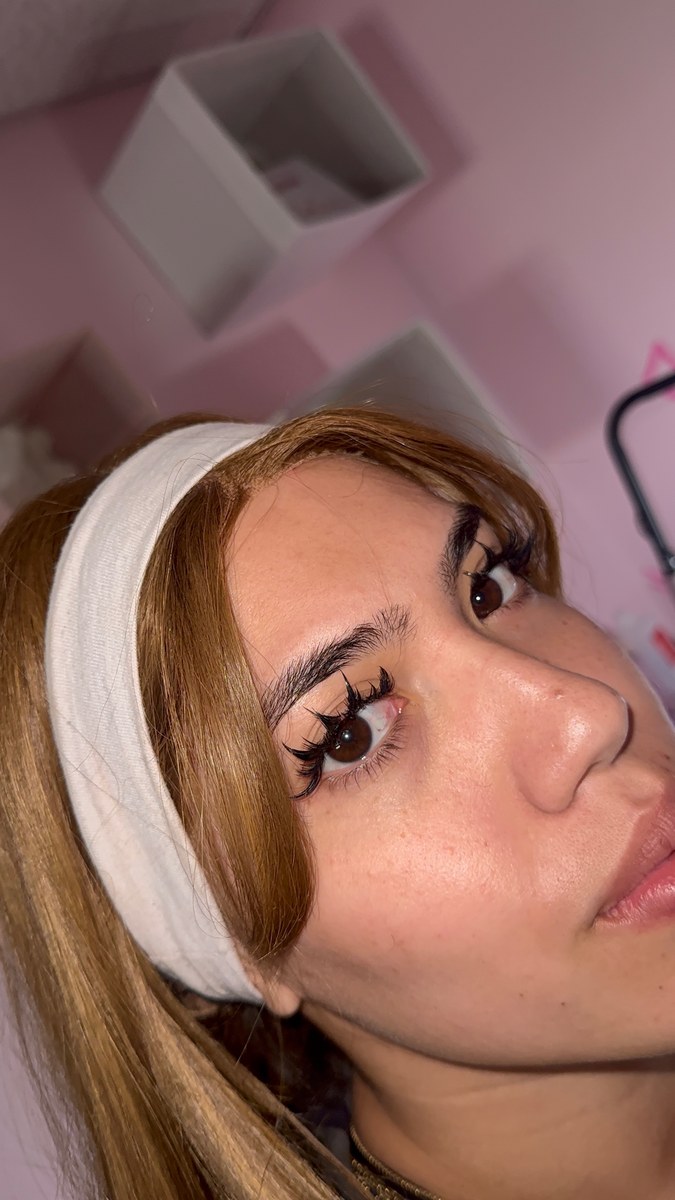 Client with wispy lash set in pink studio