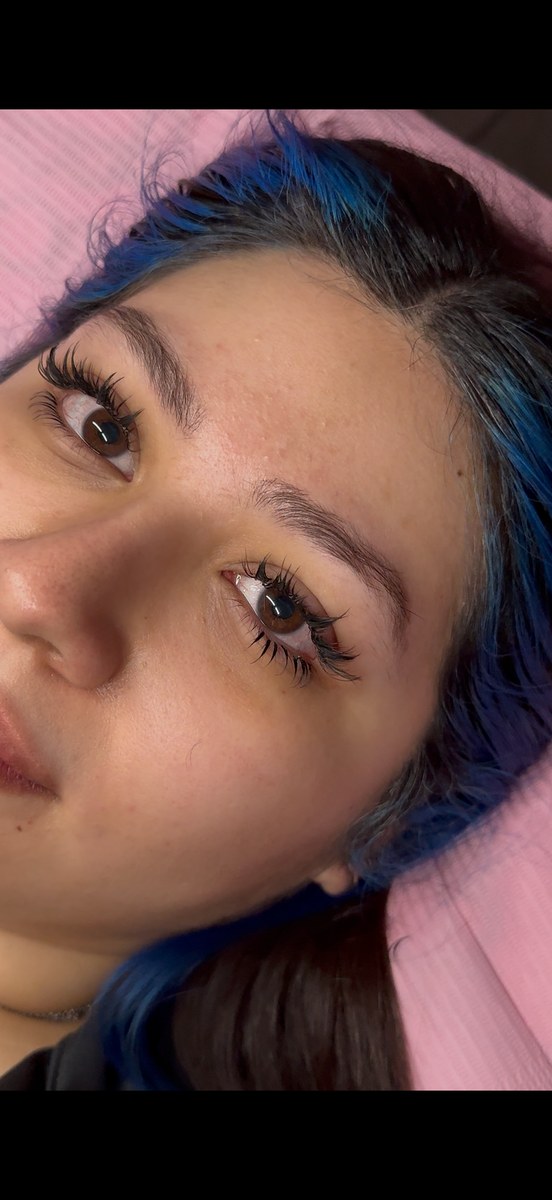 Client with blue hair and lash extensions